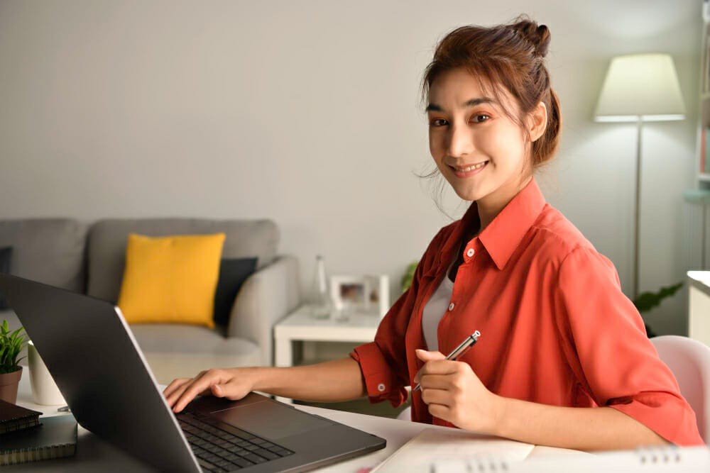 young-asian-businesswoman-sitting-home-working-laptop-computer-asian-woman-studying-online-using-laptop-surfing-information-shopping-internet-store